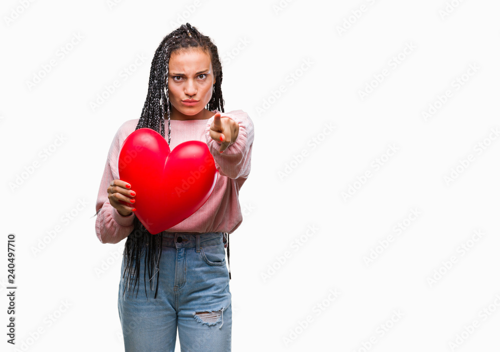 Young braided hair african american girl holding read heart over isolated background pointing with finger to the camera and to you, hand sign, positive and confident gesture from the front Young braided hair african american girl holding read heart over isolated background pointing with finger to the camera and to you, hand sign, positive and confident gesture from the front
