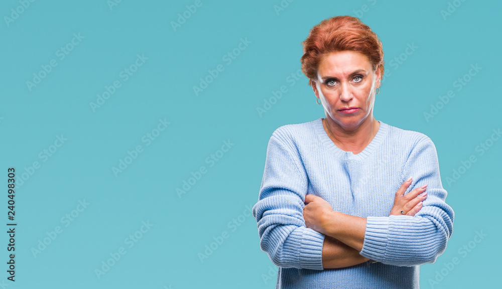 Atrractive senior caucasian redhead woman over isolated background skeptic and nervous, disapproving expression on face with crossed arms. Negative person. Atrractive senior caucasian redhead woman over isolated background skeptic and nervous, disapproving expression on face with crossed arms. Negative person.