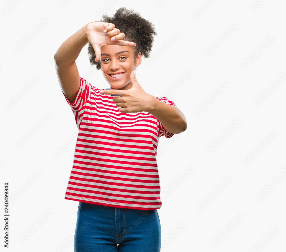 Young afro american woman over isolated background smiling making frame with hands and fingers with happy face. Creativity and photography concept. Young afro american woman over isolated background smiling making frame with hands and fingers with happy face. Creativity and photography concept.