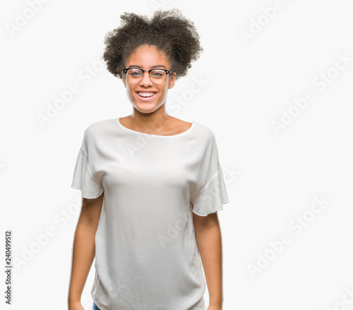 Young afro american woman wearing glasses over isolated background with a happy and cool smile on face. Lucky person.