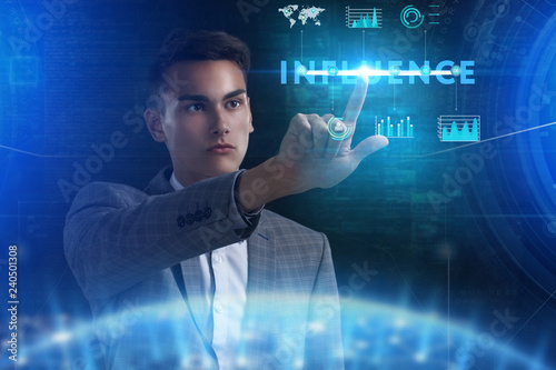 The concept of business, technology, the Internet and the network. A young entrepreneur working on a virtual screen of the future and sees the inscription: Influence