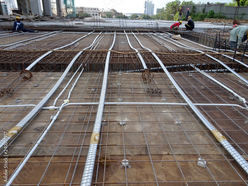 Pre-stress cable laid in round ducting and install in between the slab steel reinforcement bar at the construction site. 