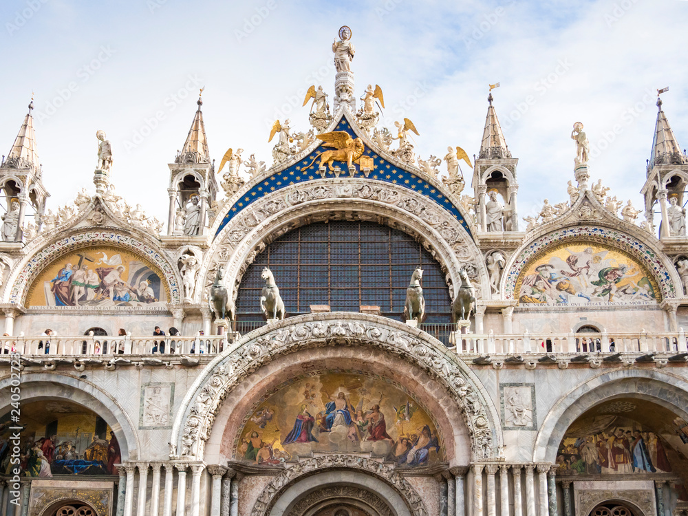 VENICE, ITALY, NOV 1st 2018: San Marco Cathedral detailed facade exterior front view. Ancient Italian renaissance architecture. Famous historic venetian landmark on Saint Marko Square or Piazza Nobody