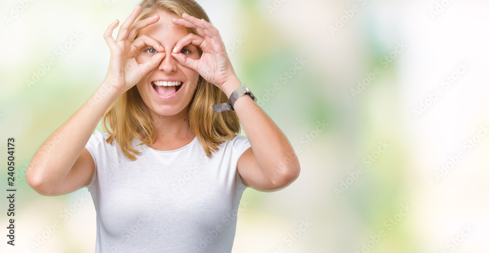 Beautiful young woman wearing casual white t-shirt over isolated background doing ok gesture like binoculars sticking tongue out, eyes looking through fingers. Crazy expression. Beautiful young woman wearing casual white t-shirt over isolated background doing ok gesture like binoculars sticking tongue out, eyes looking through fingers. Crazy expression.