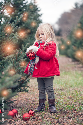 Portrait of little girl standing with bauble in hands