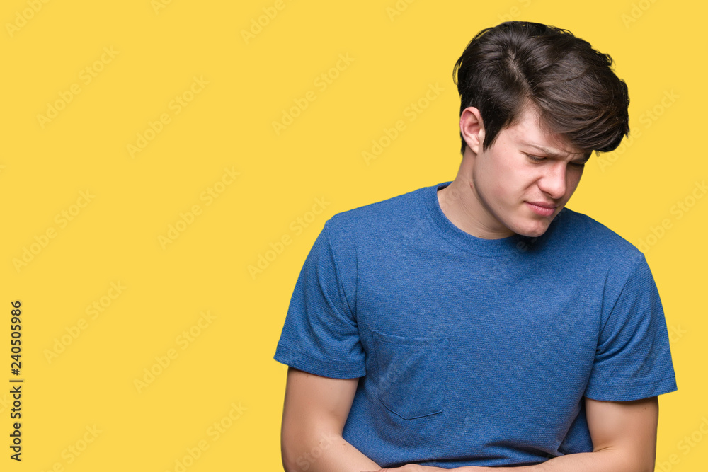 Young handsome man wearing blue t-shirt over isolated background with hand on stomach because indigestion, painful illness feeling unwell. Ache concept. Young handsome man wearing blue t-shirt over isolated background with hand on stomach because indigestion, painful illness feeling unwell. Ache concept.