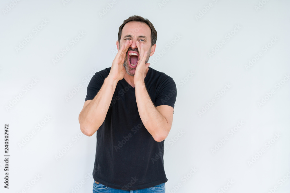 Senior man over isolated background Shouting angry out loud with hands over mouth Senior man over isolated background Shouting angry out loud with hands over mouth
