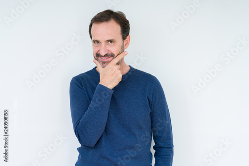 Elegant senior man over isolated background looking confident at the camera with smile with crossed arms and hand raised on chin. Thinking positive.