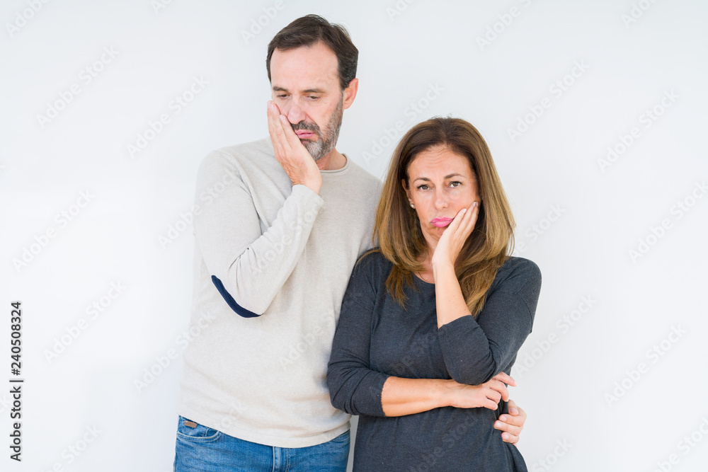 Beautiful middle age couple in love over isolated background thinking looking tired and bored with depression problems with crossed arms. Beautiful middle age couple in love over isolated background thinking looking tired and bored with depression problems with crossed arms.