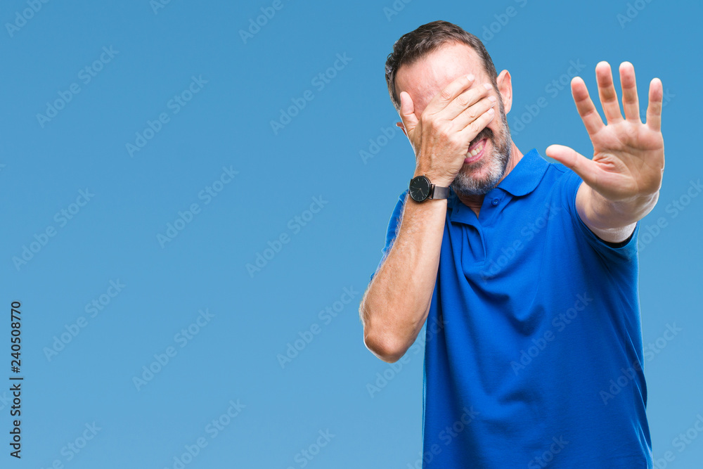 Fototapeta premium Middle age hoary senior man over isolated background covering eyes with hands and doing stop gesture with sad and fear expression. Embarrassed and negative concept.