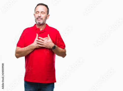 Middle age hoary senior man over isolated background smiling with hands on chest with closed eyes and grateful gesture on face. Health concept.