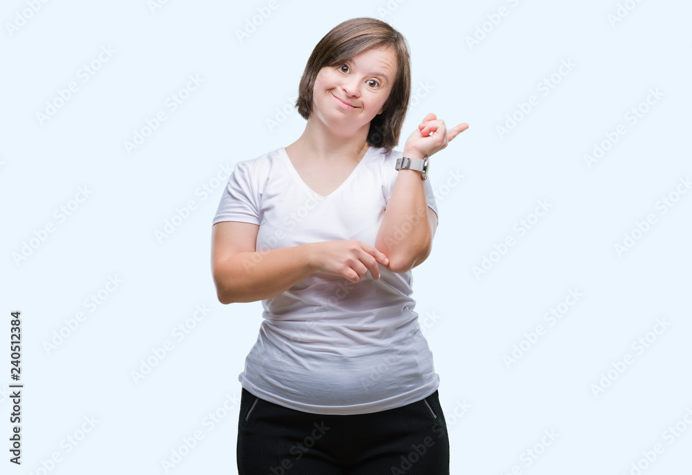 Young adult woman with down syndrome over isolated background with a big smile on face, pointing with hand and finger to the side looking at the camera. Young adult woman with down syndrome over isolated background with a big smile on face, pointing with hand and finger to the side looking at the camera.