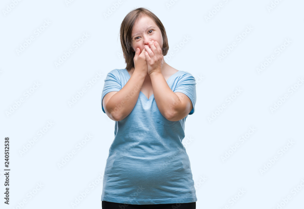 Young adult woman with down syndrome over isolated background shocked covering mouth with hands for mistake. Secret concept. Young adult woman with down syndrome over isolated background shocked covering mouth with hands for mistake. Secret concept.