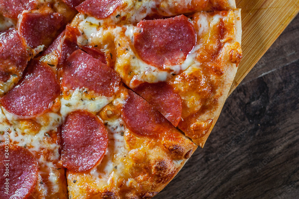 Pepperoni Pizza with Mozzarella cheese, salami, Tomatoes, pepper. Italian pizza on wooden table background Pepperoni Pizza with Mozzarella cheese, salami, Tomatoes, pepper. Italian pizza on wooden table background