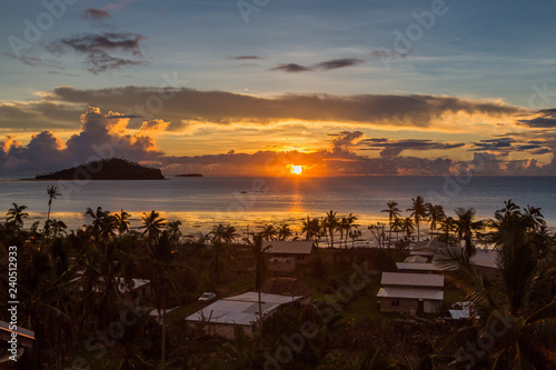 Early morning and sunrise over Pacific Ocean in Mata-Utu village, the capital of Wallis and Futuna territory (Wallis-et-Futuna), French overseas island collectivity. Downtown is overgrown with palms photo