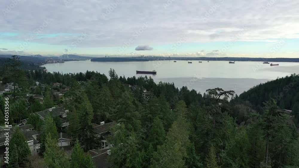 Aerial view over Burrard Inlet, ocean and island with boat and mountains in beautiful British Columbia. Canada. Aerial view over Burrard Inlet, ocean and island with boat and mountains in beautiful British Columbia. Canada.