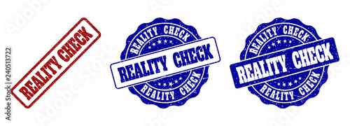 REALITY CHECK grunge stamp seals in red and blue colors. Vector REALITY CHECK overlays with grunge surface. Graphic elements are rounded rectangles, rosettes, circles and text labels.