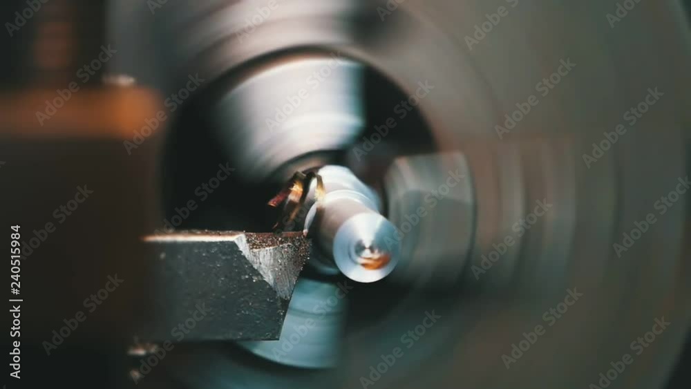 Chisel cutting flakes from a metallic rod fixed to a lathe cylinder on big plant Chisel cutting flakes from a metallic rod fixed to a lathe cylinder on big plant