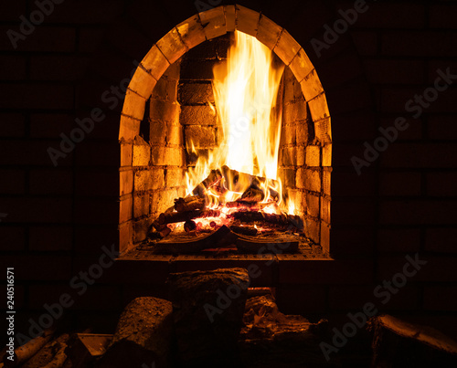 fireplace with burning firewood at night