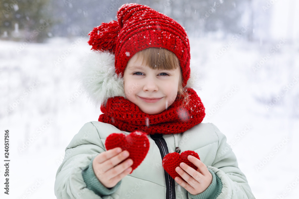 A child is showing two small heart. A child is showing two small heart.