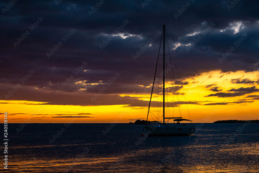 Yacht silhouette at sunset at the sea shore