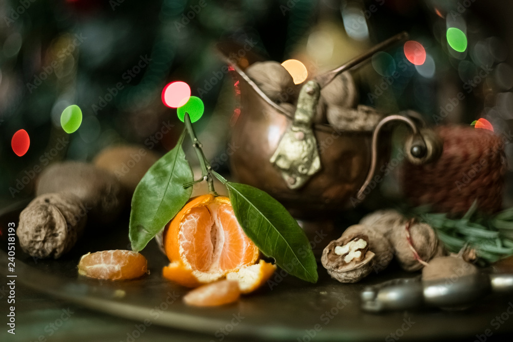 Mandarin with leaves on a tray with walnuts. copy space Mandarin with leaves on a tray with walnuts. copy space