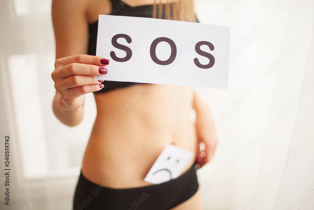 Woman Health. Female Body Holding Symbol Help Card Near Stomach