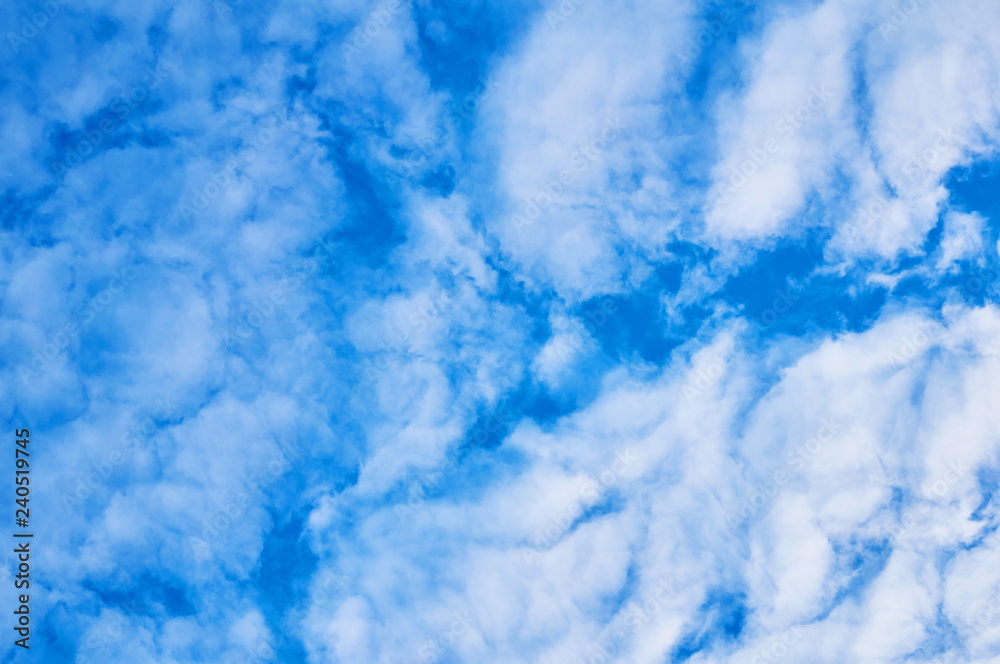 Deep blue sky with clouds below. Abstract background.