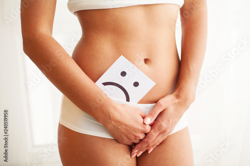 Woman Health. Female Body Holding Sad Smile Card Near Stomach