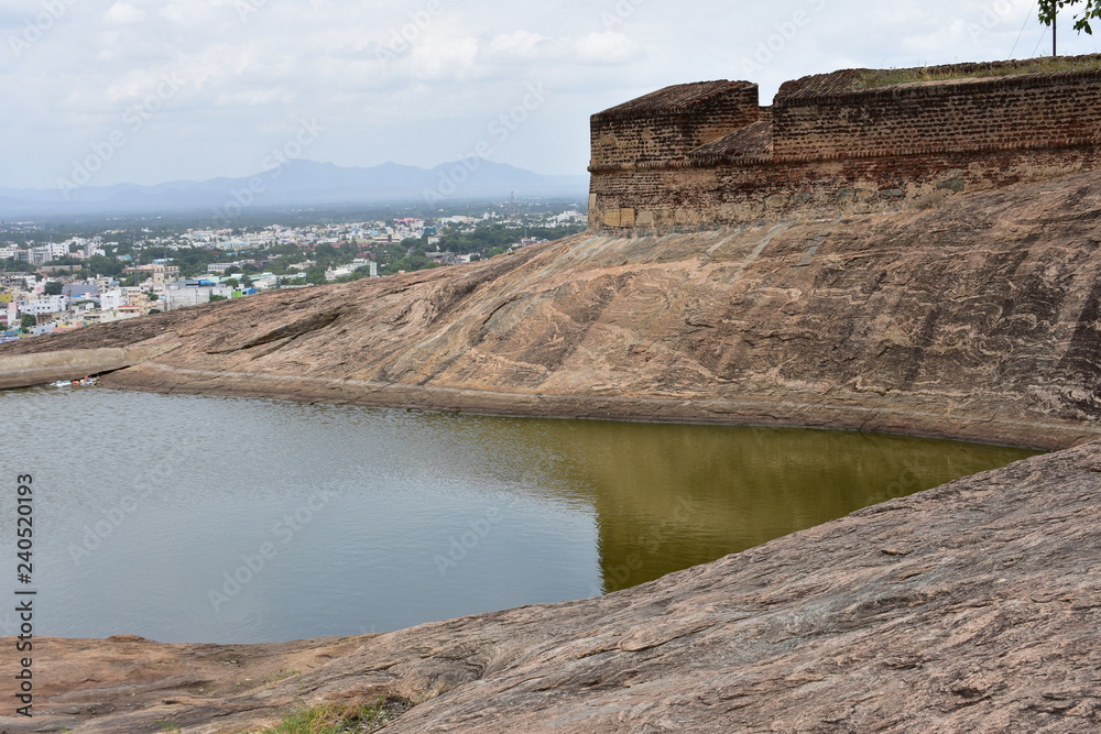 Dindigul, Tamilnadu, India - July 13, 2018: Pond and cave in Dindigul Rock Fort