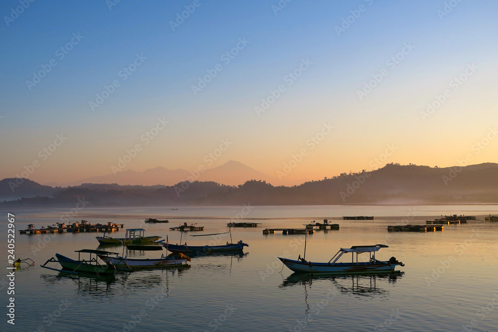 Black fishermans boats silhouettes in the morning at Lombok island, Indonesia