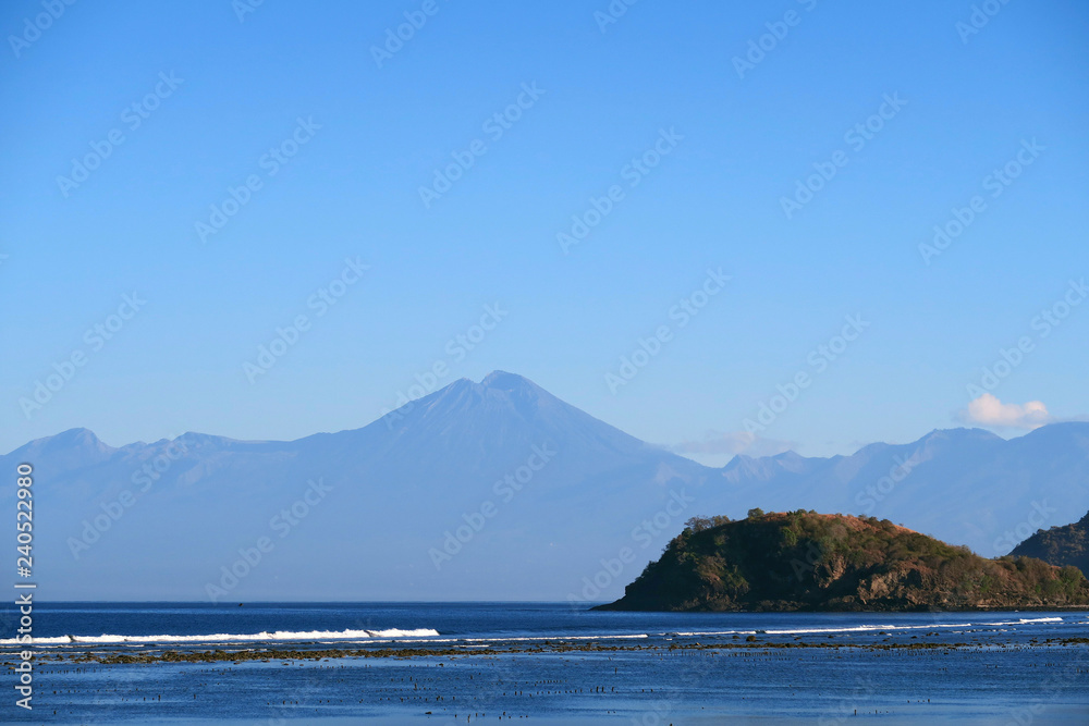 Ocean bay with rocks and blue mountains, Sumbawa island, Indonesia Ocean bay with rocks and blue mountains, Sumbawa island, Indonesia