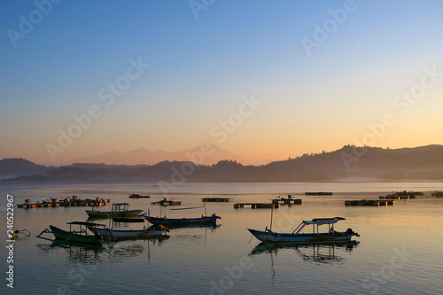 Black fishermans boats silhouettes in the morning at Lombok island, Indonesia © art_of_sun