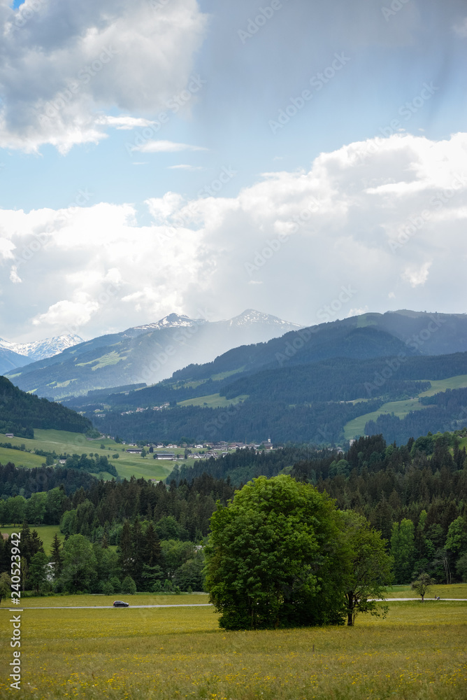 Nahender Regen in einem Tal in den Tiroler Bergen mit Blickrichtung Brixental