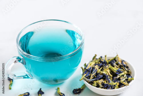 Cup of Butterfly pea tea or blue tea for healthy detox drinking on white marble table