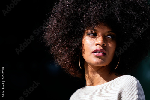 Portrait of attractive afro woman in over the wall