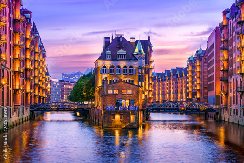 The Warehouse District (Speicherstadt) in Hamburg, Germany, at dusk. View of Wandrahmsfleet. The largest warehouse district in the world is located in the port of Hamburg within the HafenCity quarter.