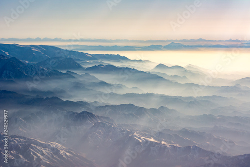 Aerial view of the fog laden Tian Shan mountain range in China near Ürümqi