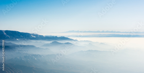 Fog covered Tian Shan mountain range in China near Ürümqi
