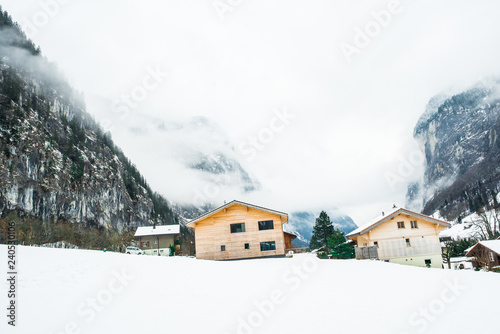 Wooden houses covered in snow in mountain region of Lauterbrunen - switzerland.