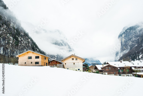 Wooden houses covered in snow in mountain region of Lauterbrunen - switzerland. photo