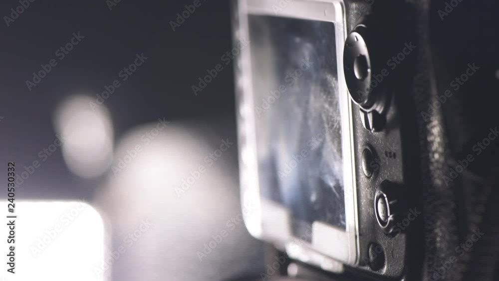 DSLR camera and led light panel in tv studio, close up with selective focus, low key slow motion