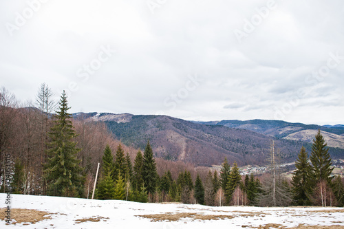 Snowy mountain valleys at Carpathian mountains. View of Ukrainian Carpathians and Yaremche from the top of Makovitsa.