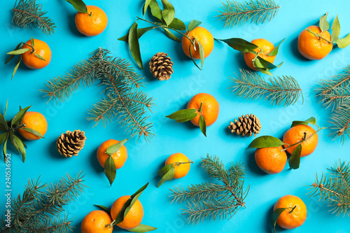 Fototapeta Naklejka Na Ścianę i Meble -  Christmas composition with ripe tangerines on color background, flat lay