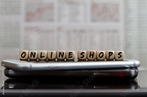 Online shops word built with letter cubes on cellular phones