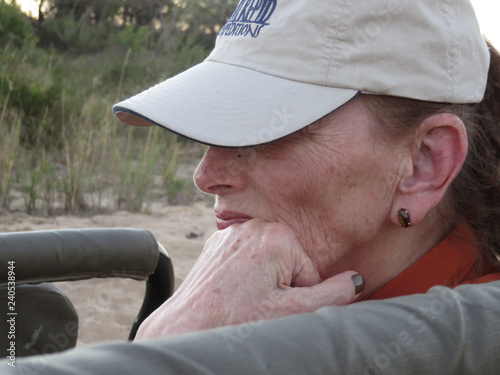 Woman on safari, fascinated by the animals photo