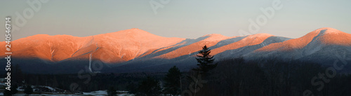 panoramic scenery of snow mountains with red sunlight on peak