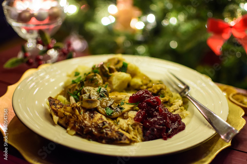 Christmas Turkey Dinner with Cranberry Sauce and illuminated Christmas Lights