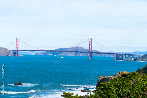 The view of golden gate bridge in Lands end at San Francisco- San Francisco. summer , cloud , rock , sea, plant.