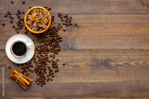 Brown roasted coffee beans scattered on wooden background top view mockup